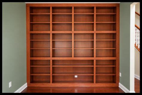 Custom cherry wood built-in bookcase in Swedesboro, New Jersey, featuring a floor-to-ceiling horizontal design with burgundy wood stain and no particle board.